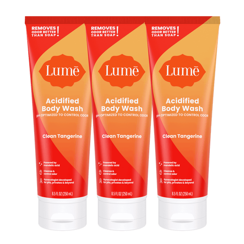 Three orange tubes of body wash in the scent Clean Tangerine