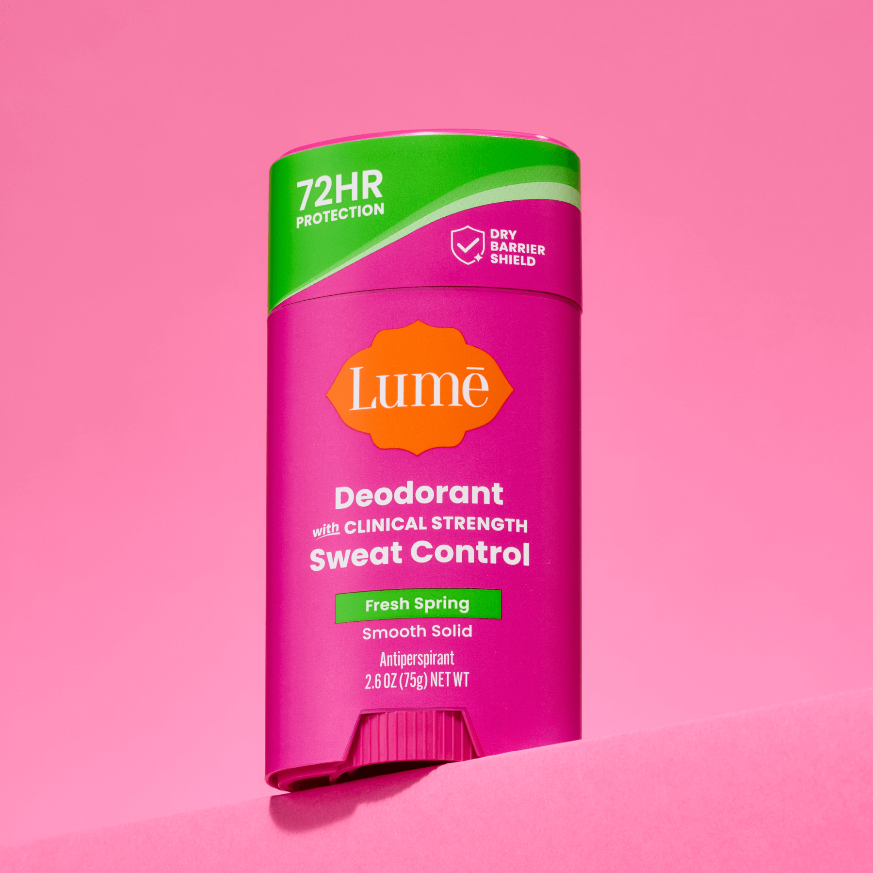 A stick of Lume deodorant plus sweat control against a pink background